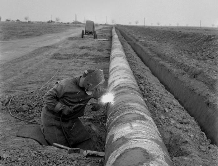 Pipeline welding - regular day, in background you can see combination of diesel aggregate with rotary welder included inside. In foreground you can see a regular hammer - we were not using any special hammer to beat out slag from welds :)