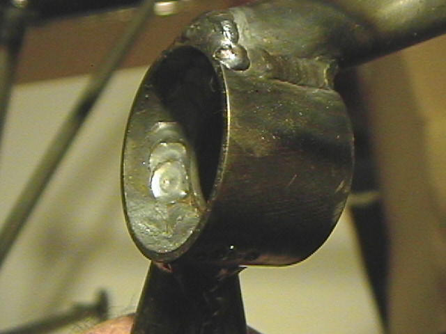 Washer MIG welded into tube for rubber thrust isolator